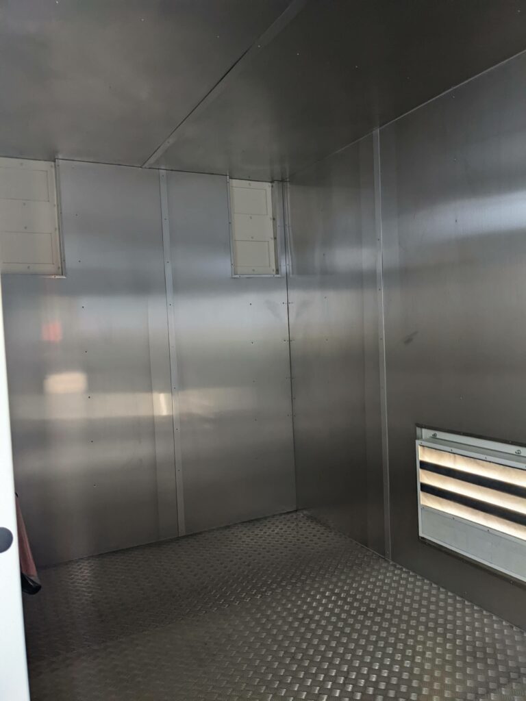 inside of a shipping container lined with aluminium
